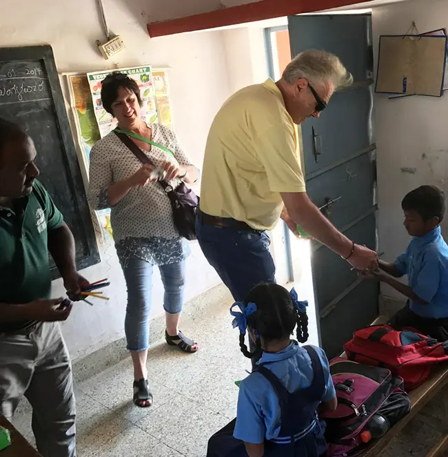 Waterwoods team members distributing school bags to children as part of community education initiative