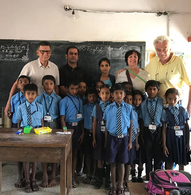 Group photo of teachers, students, and Waterwoods CSR volunteers during school education event in Kabini