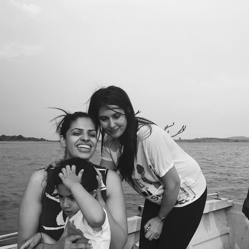 Family members of Waterwoods founders smiling on a boat ride in Kabini backwaters