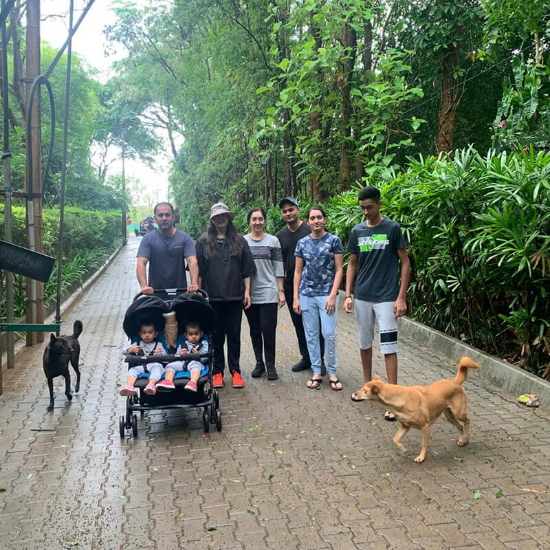 Waterwoods founders and family walking with their dogs along a forest pathway in Kabini