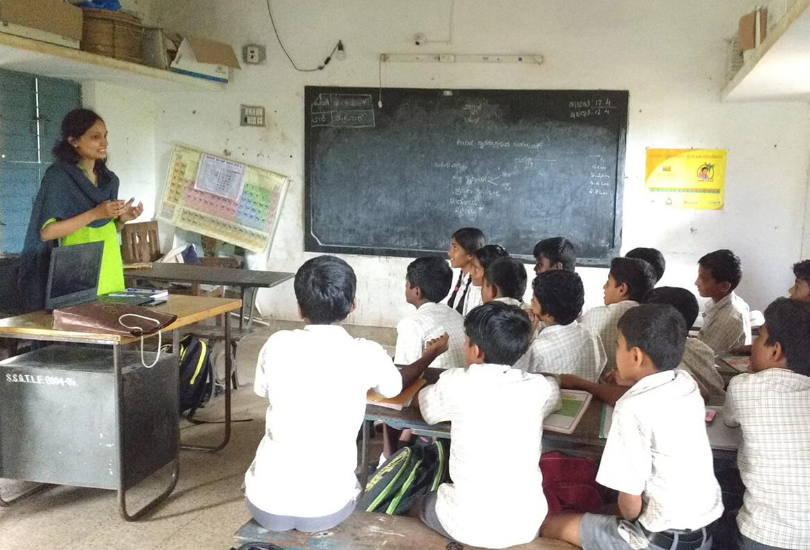 Teacher conducting an interactive classroom session for local students under Waterwoods Kabini’s education support program.