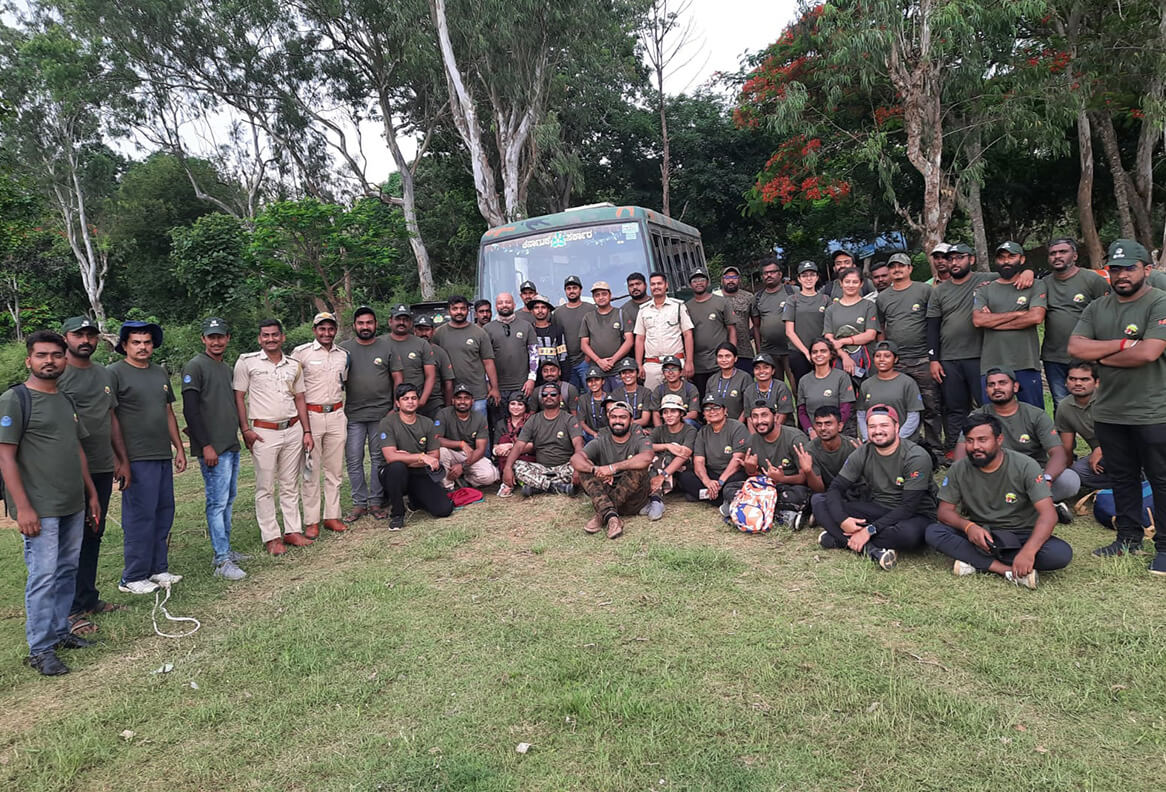 Waterwoods Kabini team and local community staff gathered outdoors promoting employment and inclusiveness.