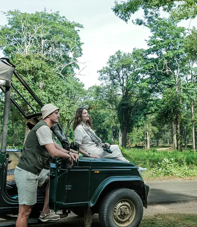 Guests sitting on a jeep preparing for their wildlife safari in Kabini forest
