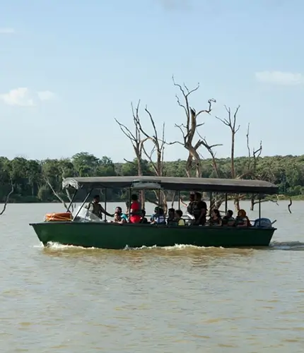 Tourists enjoying a scenic boat ride to Bheemankoli temple across the Kabini River
