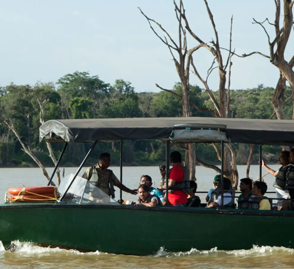 Visitors Traveling by Boat Across Kabini River to Visit Ancient Temple near Waterwoods Lodge