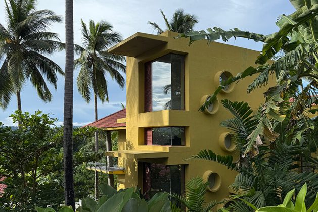 Modern architectural villa at Waterwoods Havelock nestled amid vibrant greenery and coconut trees.