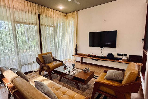 Spacious villa living room at Waterwoods Havelock with modern wooden furniture and soft natural light.